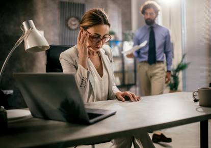 Woman annoyed while man hands her paper - Whistleblower Protection